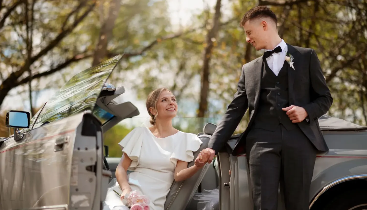 just-married-couple-with-their-car